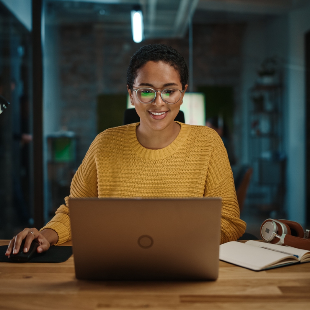 Women smiling and looking at laptop